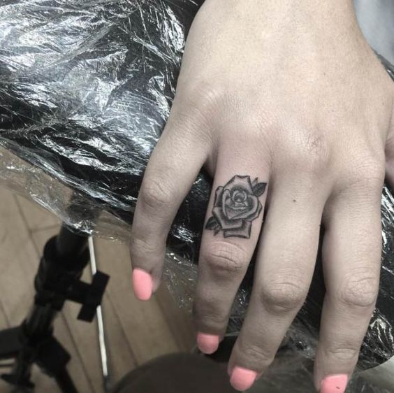 Delicate Monochrome Finger Rose Tattoo