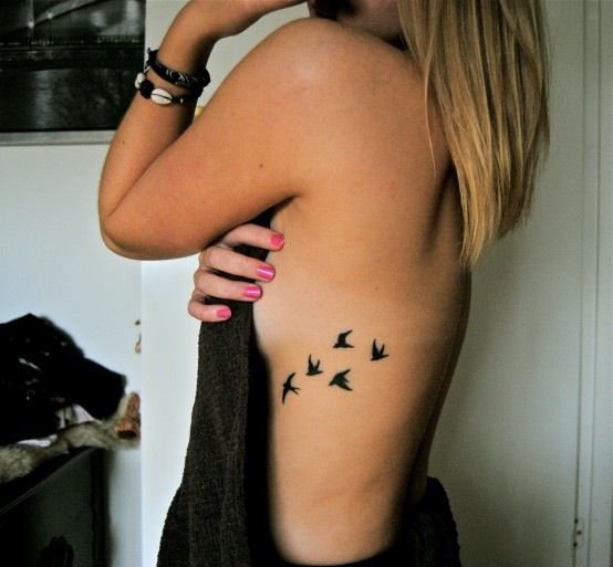 flying bird side tattoo