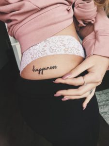 happiness quote hip tattoo