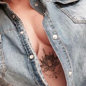 under chest lotus tattoo