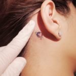 planet-behind-the-ear-tattoo