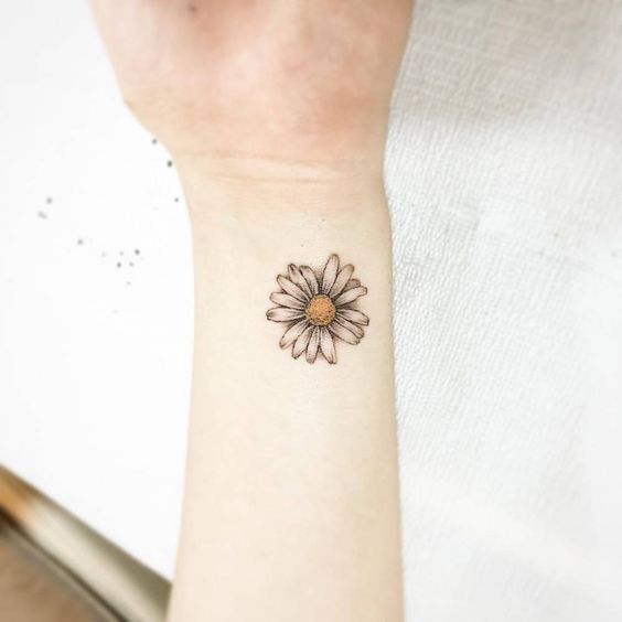wrist daisy flower tattoo